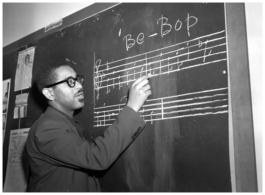 Trumpeter Dizzy Gillespie writes a phrase of "Be-Bop" music on the blackboard in New York, May 1, 1947. (AP Photo)
